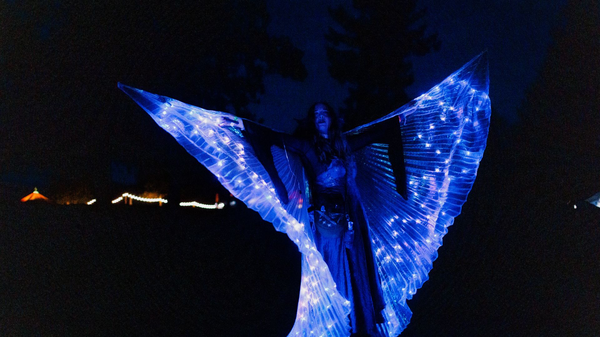LED wing dancer performing at night